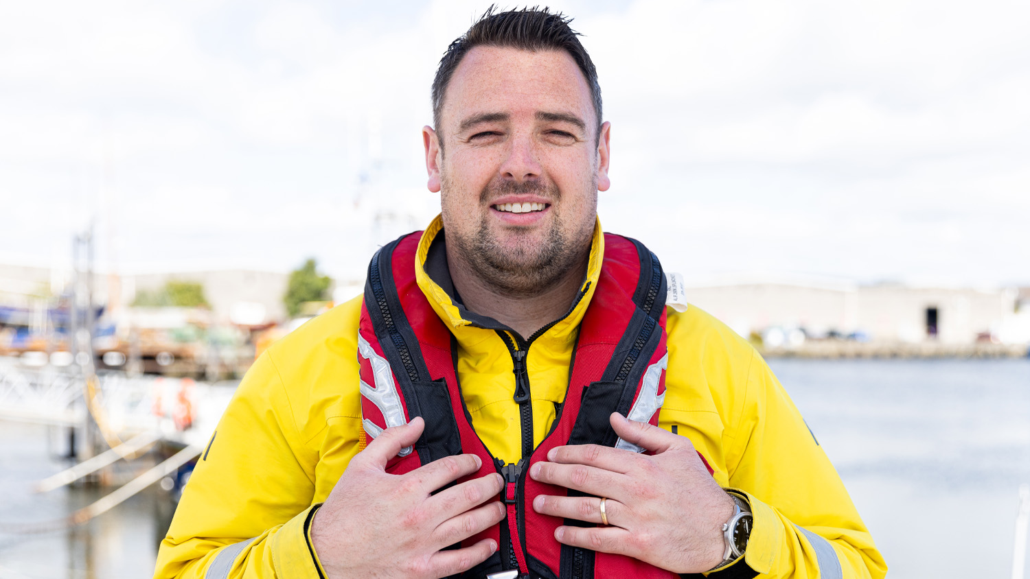 A shot of a man dressed in RNLI lifeboat crew gear