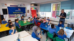 RNLI youth education volunteers present at a school