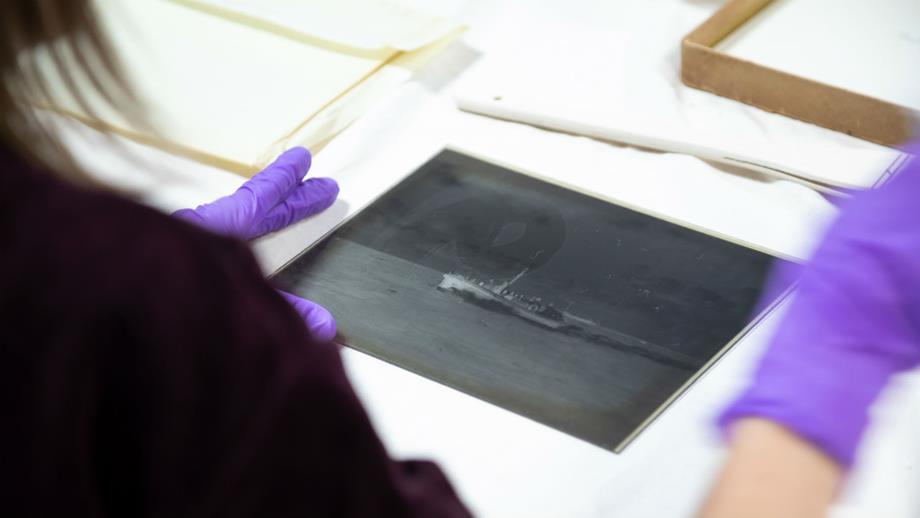 Colour image of Beken volunteer preparing glass plate negative