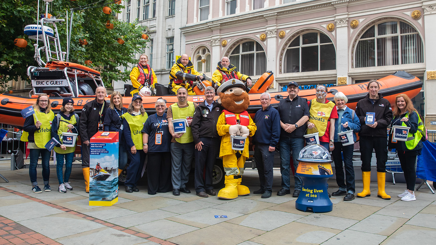 RNLI Lifeboat Saturday first street collection in Manchester in 1891 with crew and fundraisers infront of their lifeboat, and a recreation more than 100 years later