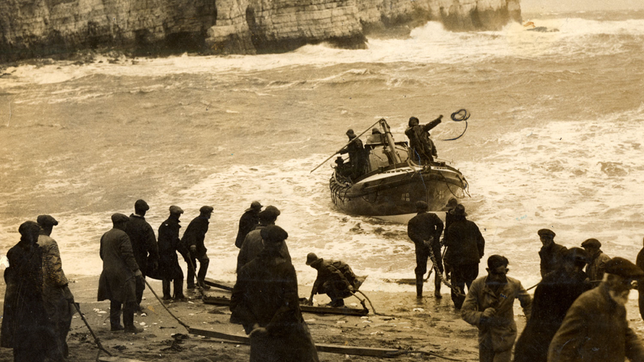 Men on shore prepare to haul the lifeboat Elizabeth and Albina Whitley onto a Yorkshire beach.