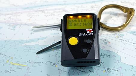 RNLI pager on a chart with a pair of dividers