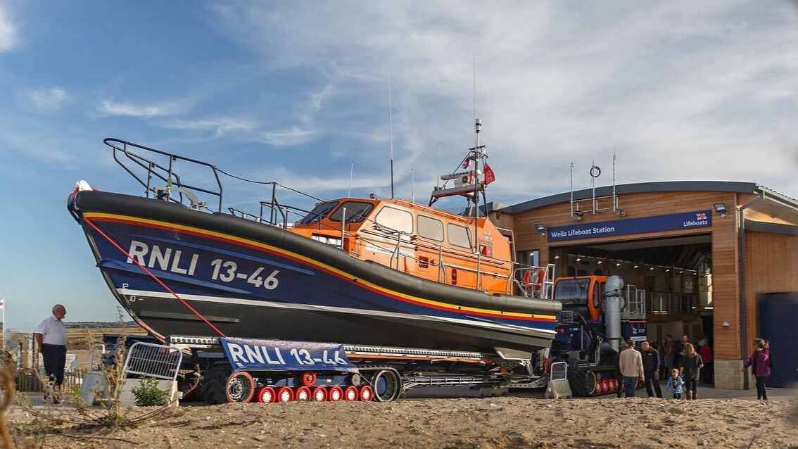 a lifeboat is parked in front of a lifeboat station.