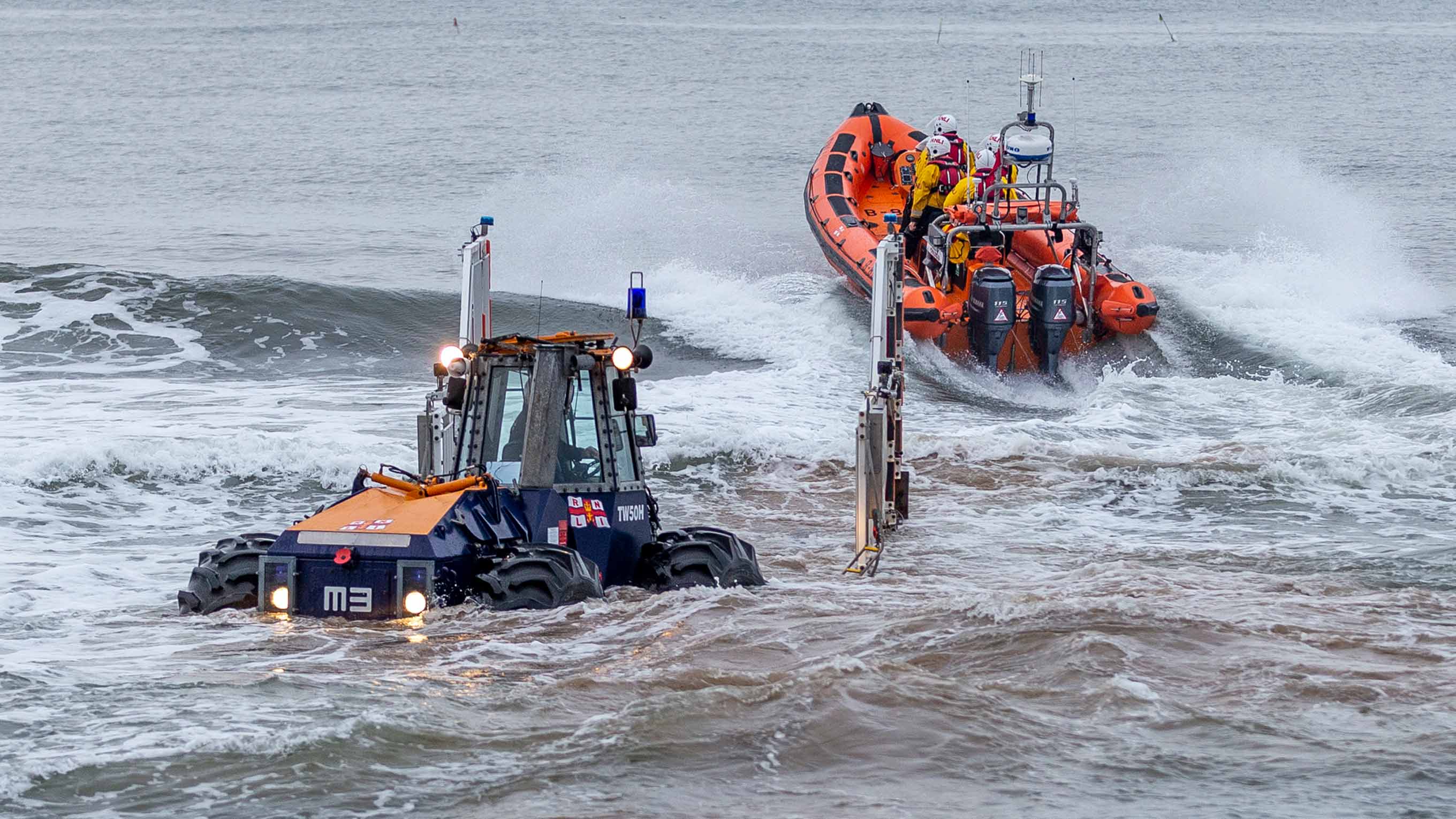 D class inshore lifeboat launches from a tractor into heavy surf