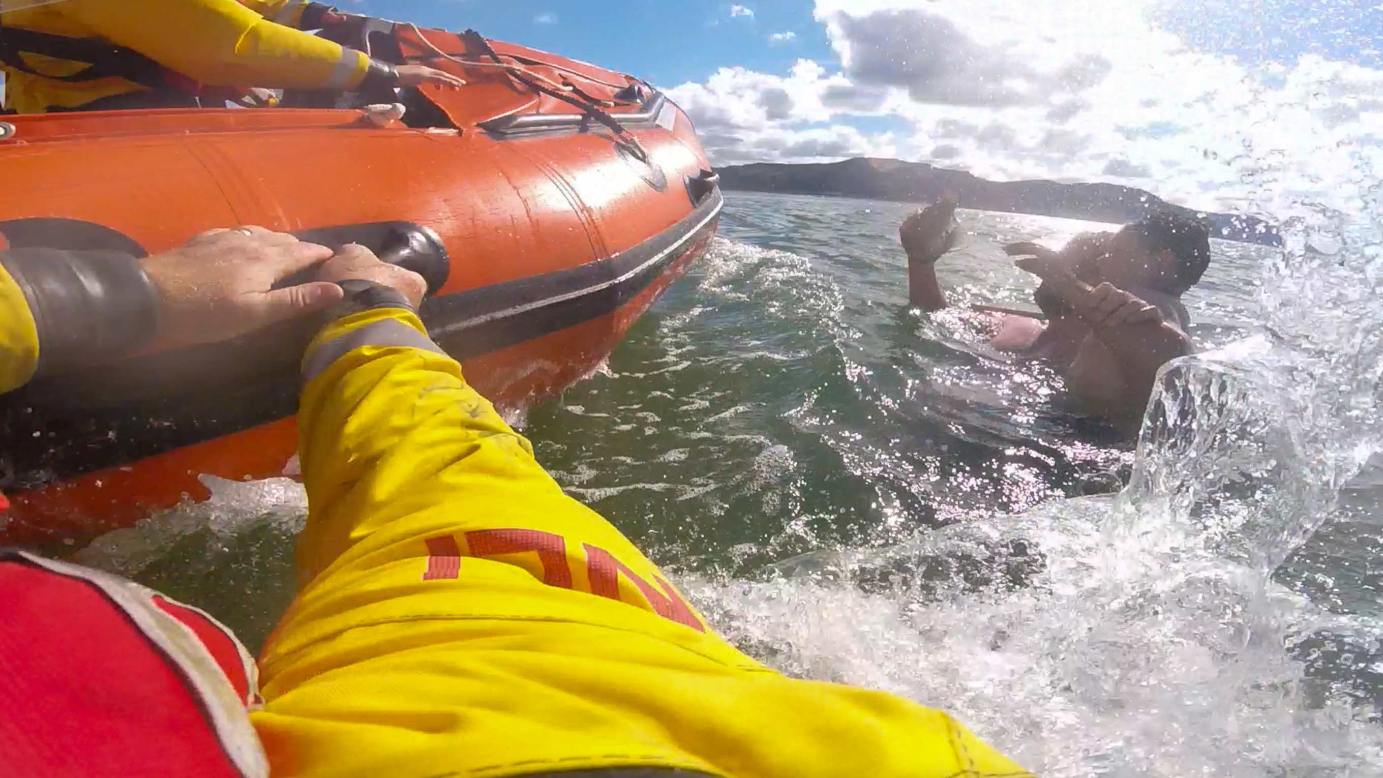 Headcam footage from a lifeboat crew member jumping into the water to save a man and child