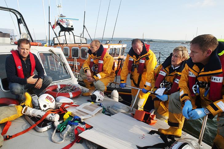 Paul Savage (left) is pictured with Poole lifeboat crew on a medical training exercise