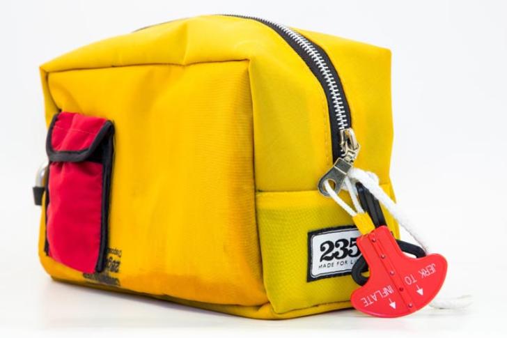 A washbag from the original yellow range reuses everything from the lifejacket’s metal D -ring to the internal pockets and manual inflation tag.