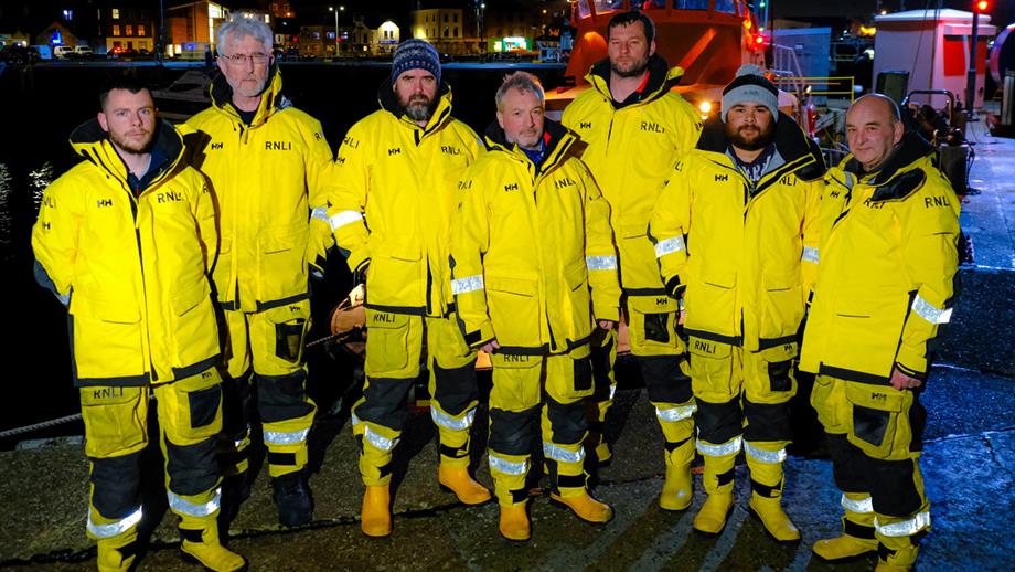 Seven members of Lerwick lifeboat crew pose for a photo wearing all-weather lifeboat kit 