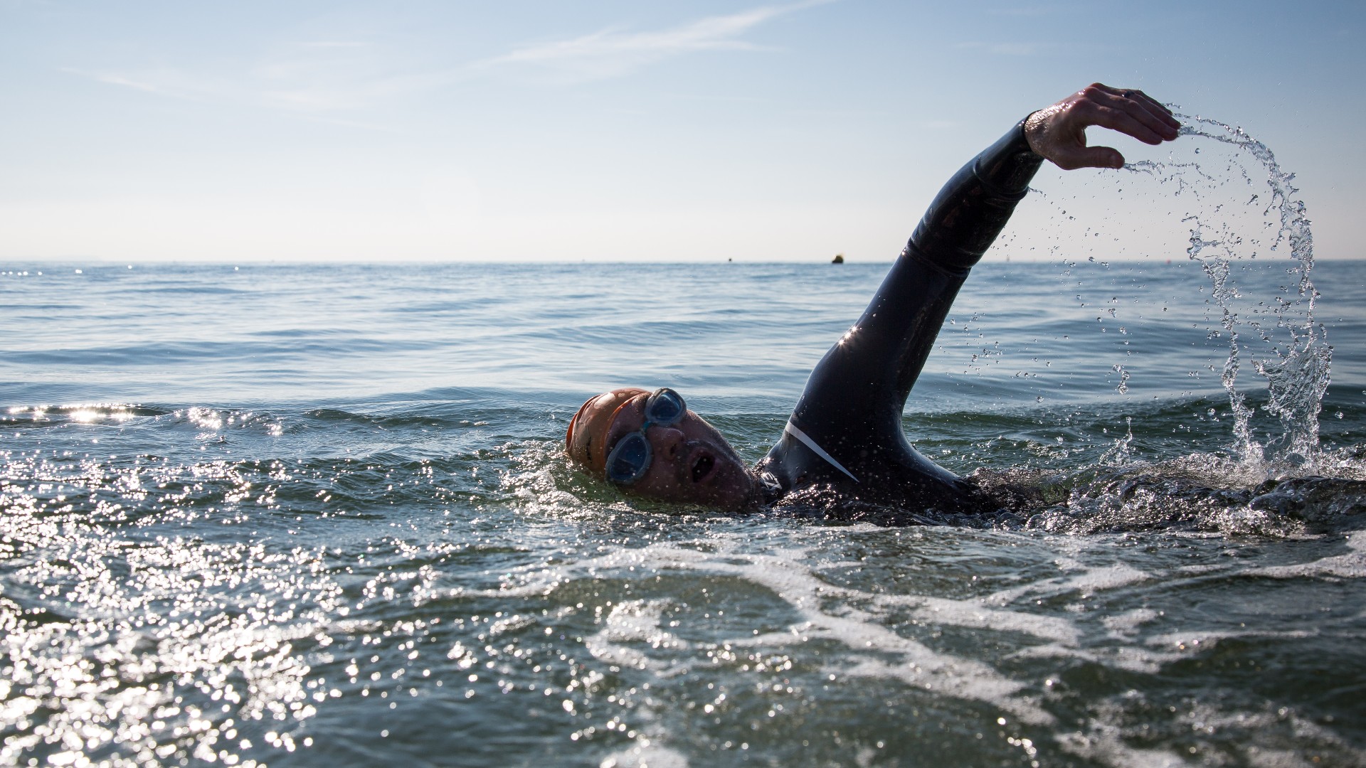 A man is swimming in open water.