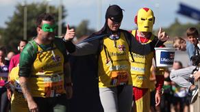Superheroes running a race for the RNLI