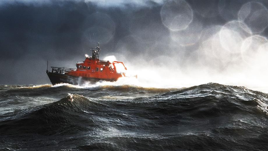 A  Severn class lifeboat  at sea during rough weather under a stormy sky.