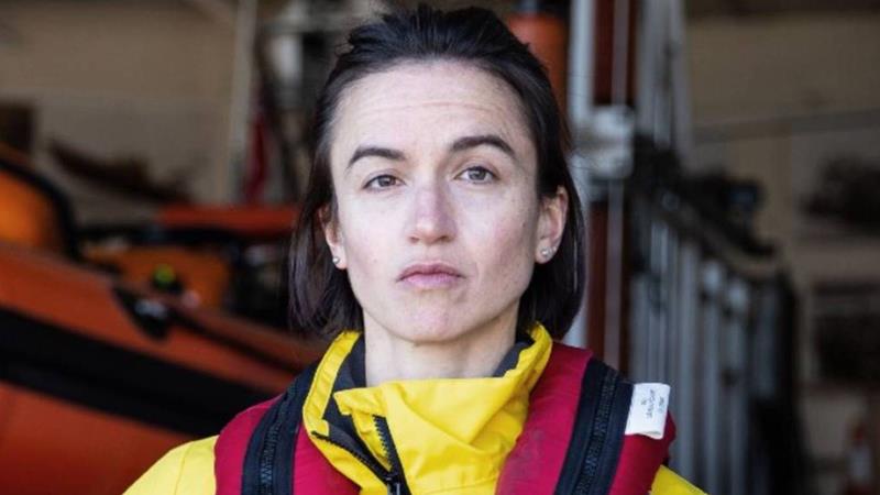 Close up of Crew Member Holly, in crew kit and looking into the camera