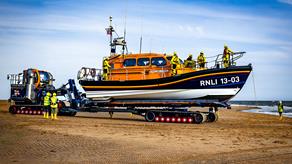 Exmouth's Shannon Class lifeboat on the sand with crew members