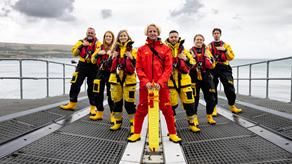 Group photo of RNLI lifesavers including lifeboat crew and a lifeguard