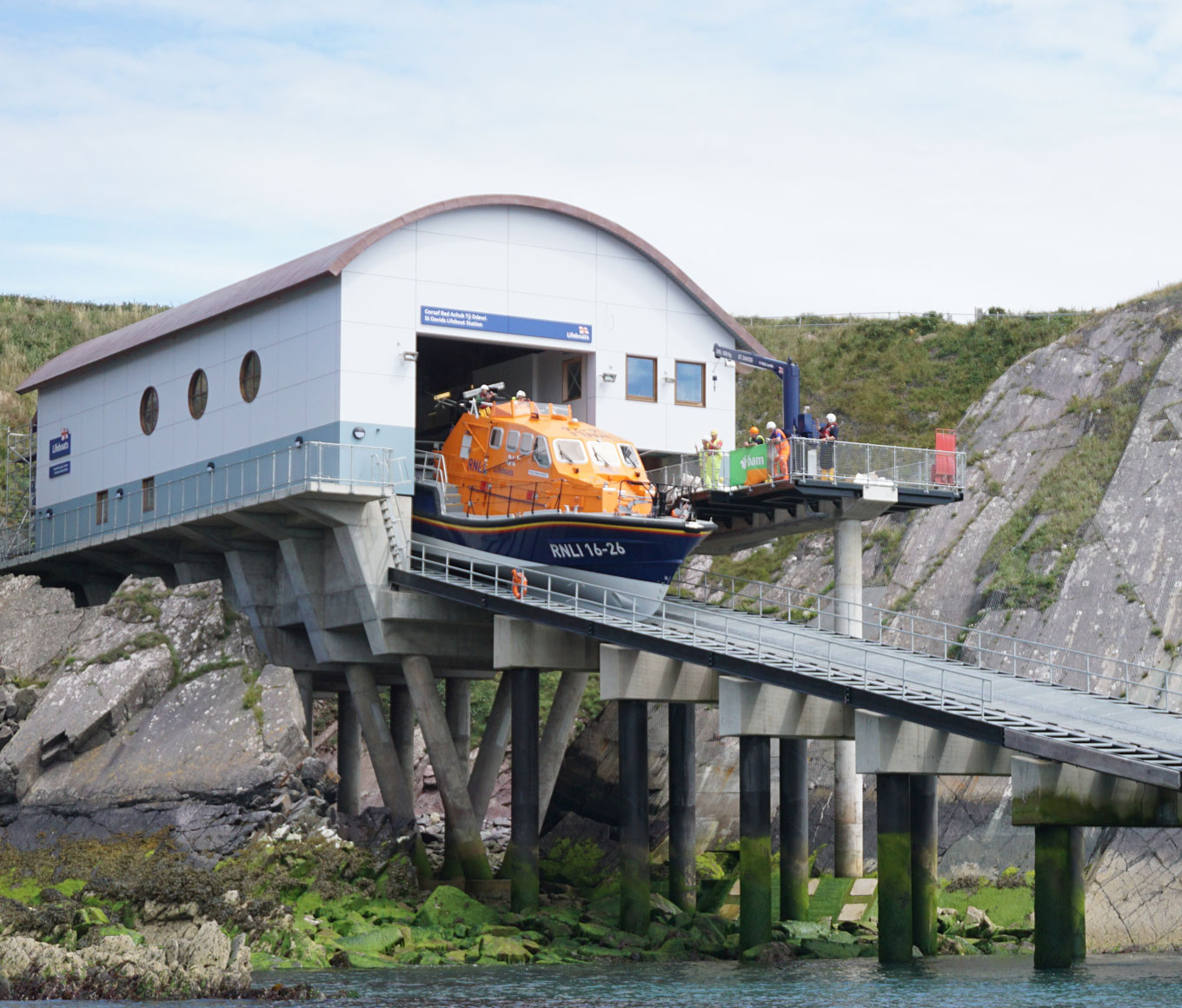 A Tamar class lifeboat emerges from St Davids boathouse at the top of a slipway