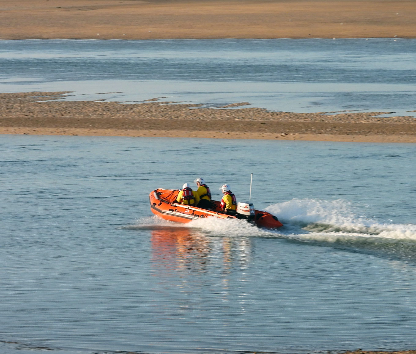 Inshore lifeboat on water at low tide