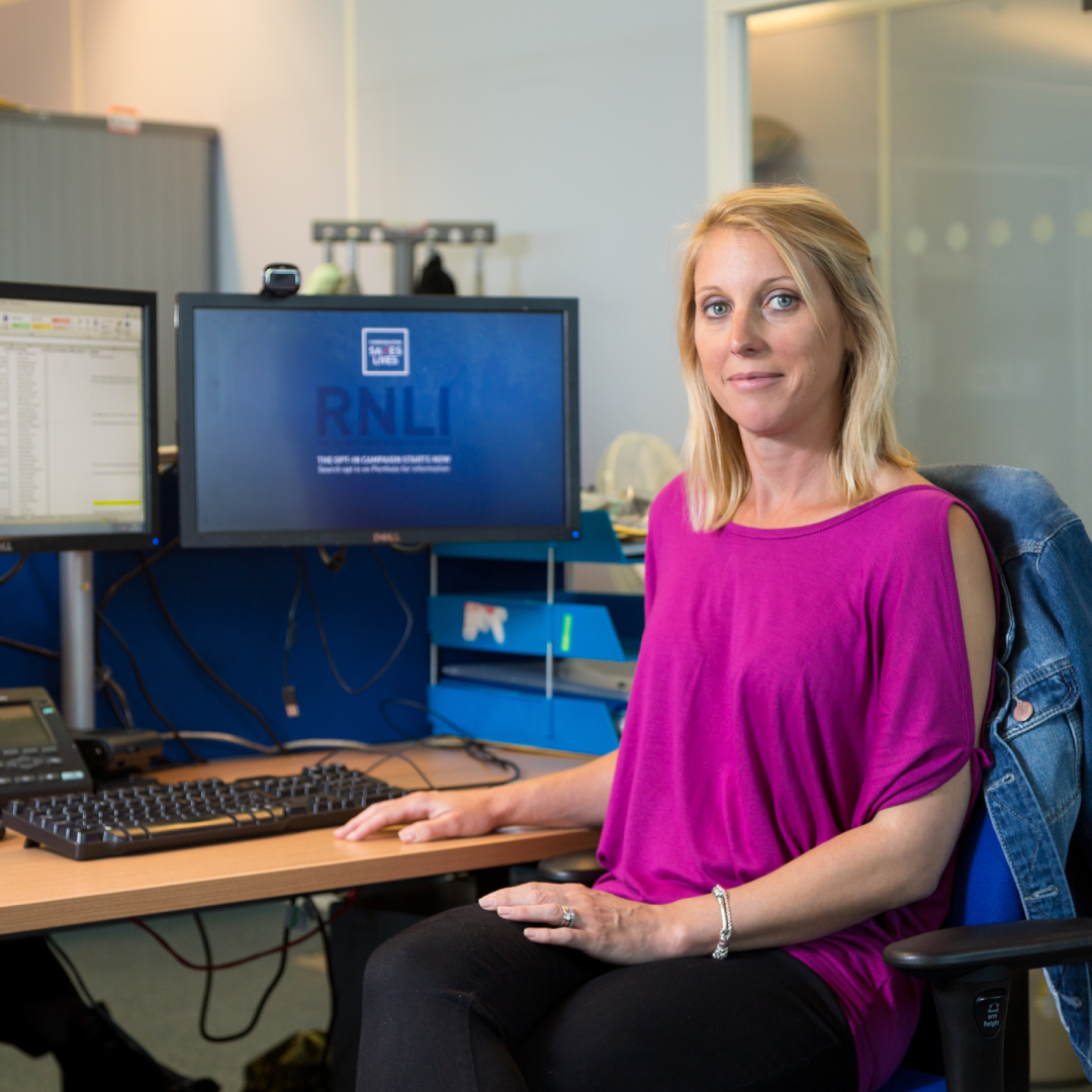 Office support volunteer Samantha Salmond sat at a desk in front of a computer, helping out in the RNLI’s People department