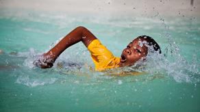 A child learning to swim in the sea on Zanzibar