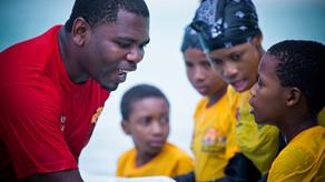 An Aquatic Survival trainer teaches children in the sea on Zanzibar
