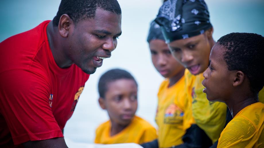 An Aquatic Survival trainer teaches children in the sea on Zanzibar