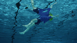 a person swimming under water.
